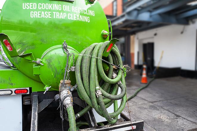 maintenance crew pumping grease trap at a fast food restaurant in Atherton